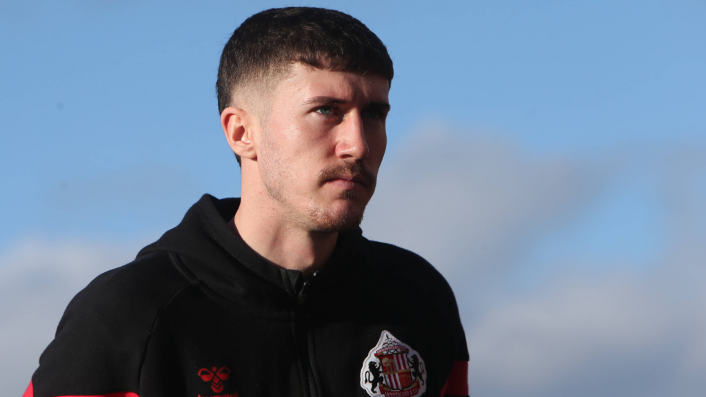 Trai Hume in his training gear in front of blue skies
