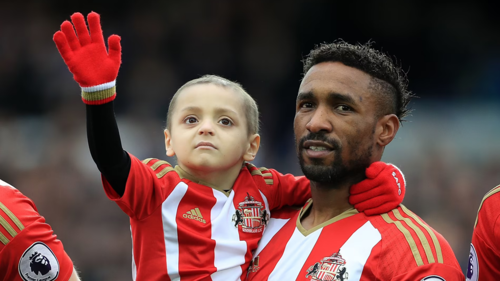 Former Sunderland striker Jermain Defoe holds Bradley Lowery.