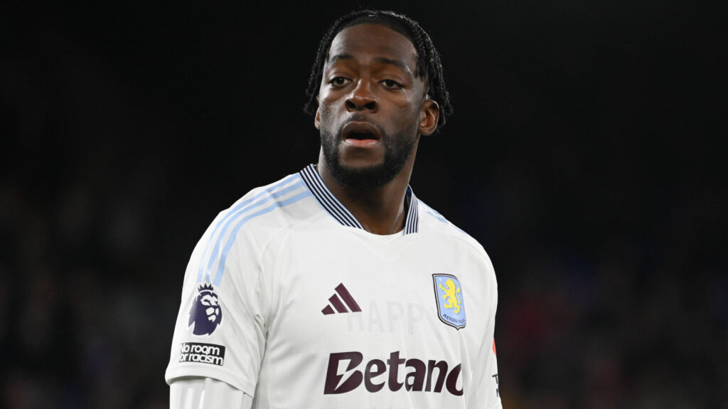 Axel Disasi playing for Aston Villa in their away strip.