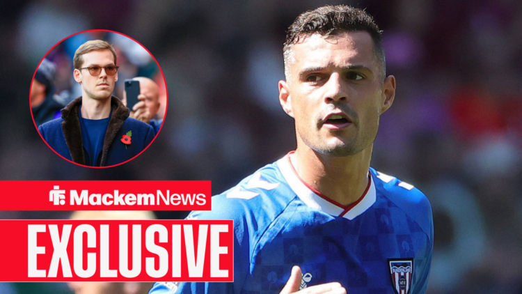 Granit Xhaka runs while Kyril Louis-Dreyfus looks at him