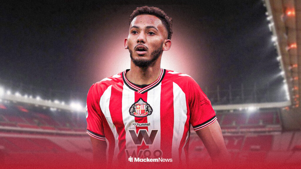 Lloyd Kelly wears a Sunderland shirt in front of the Stadium of Light.