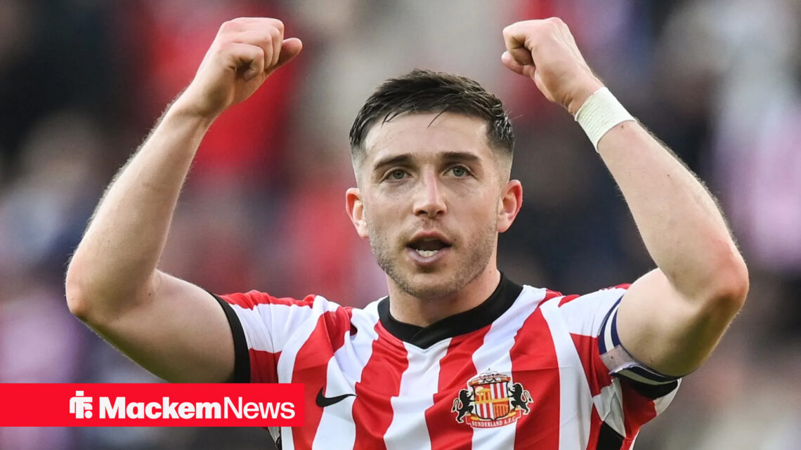 Lyden Gooch with his arms raised in celebration