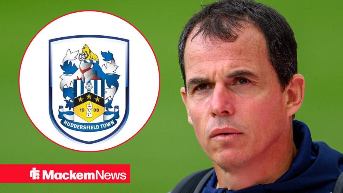 Regis Le Bris looks curiously at the Huddersfield Town badge