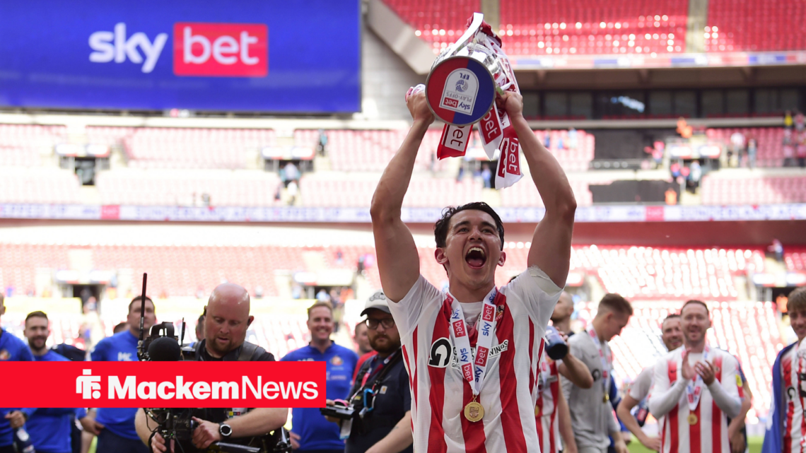 Luke O'Nien lifts the League One play-off trophy for Sunderland.