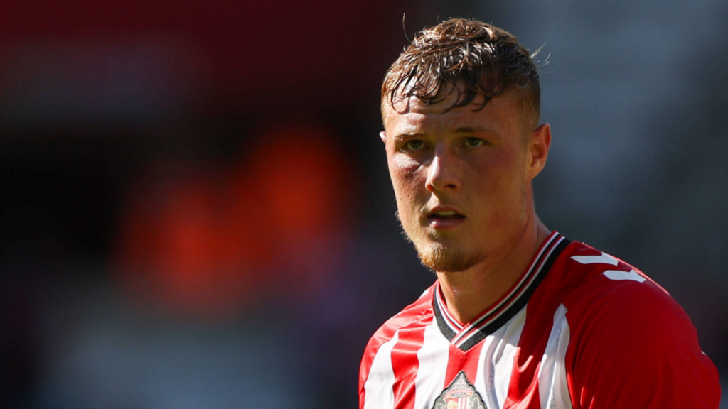 Dan Ballard in action for Sunderland in front of a dark backdrop.