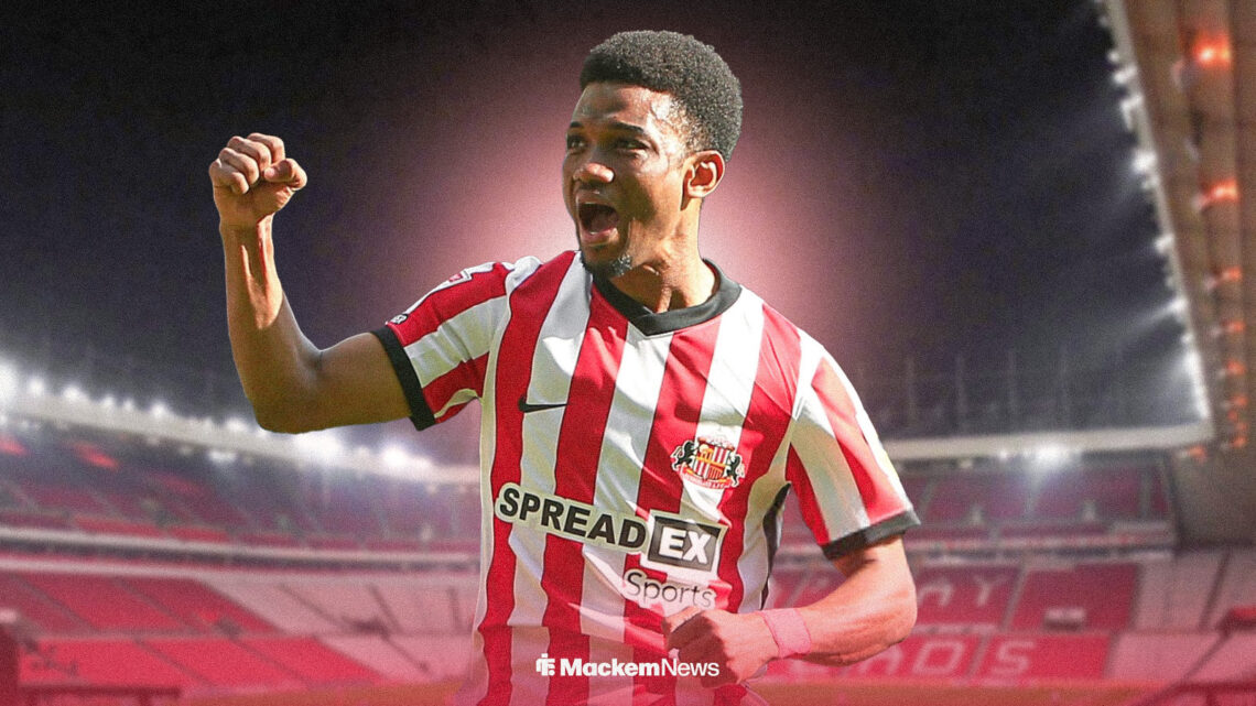 Amad Diallo celebrates in front of the Stadium of Light wearing a Sunderland shirt.