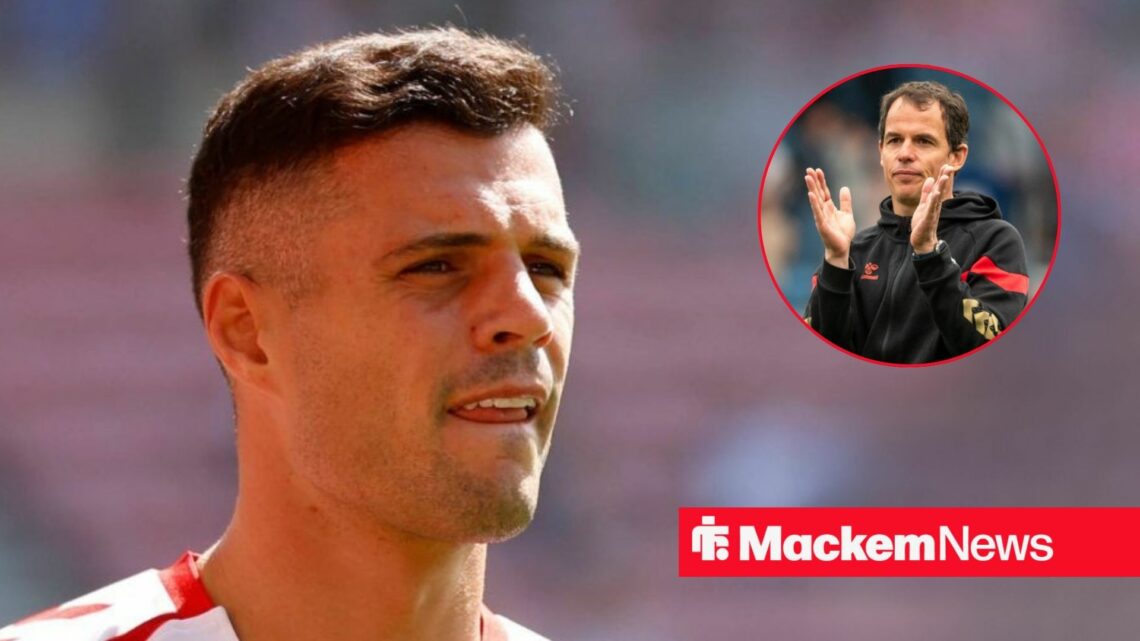 Granit Xhaka looking serious with Regis Le Bris in frame