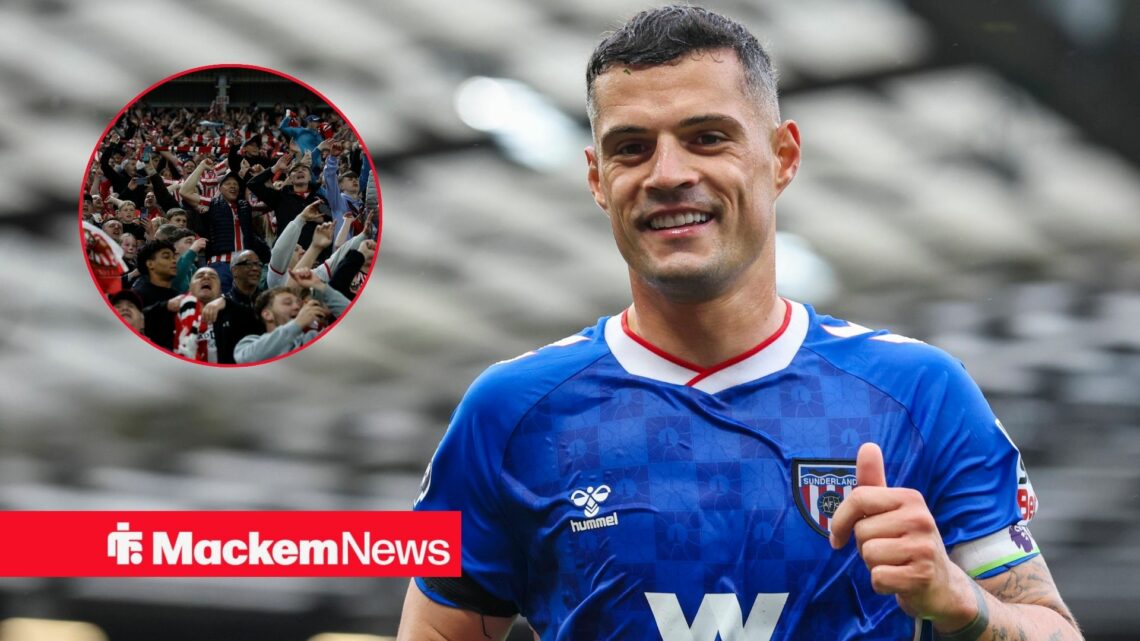 Granit Xhaka smiling with Sunderland fans in frame