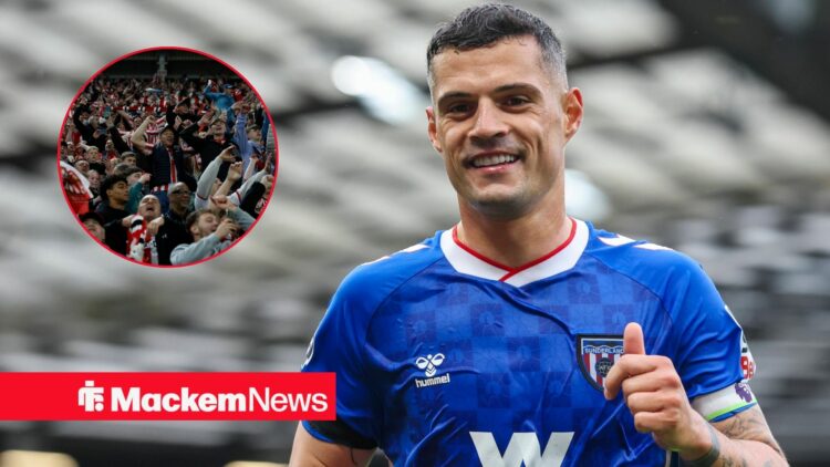Granit Xhaka smiling with Sunderland fans in frame