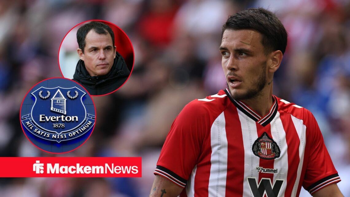 Enzo Le Fee and Regis Le Bris looking at each other with a serious look as the Everton badge looms.